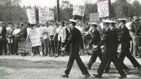 Navy ROTC trainees march past protesters from Students for a Democratic Society (SDS) at Chase Field on May 15, 1968.