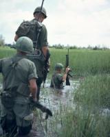 United States Army infantrymen of the 2nd Battalion, 12th Infantry, 25th Infantry Division move through the water on a daylight patrol northwest of Cu Chi, Vietnam, in November 1969. Photo by Jeffrey H. Hinman '68.